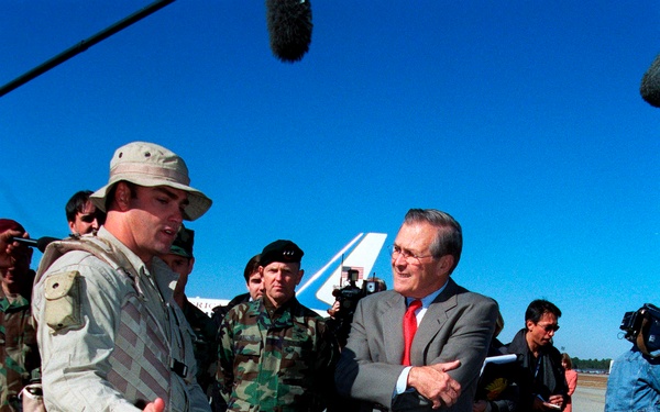 A Navy SEAL explains tactical observation equipment to Secretary Rumsfeld during his visit to Pope.