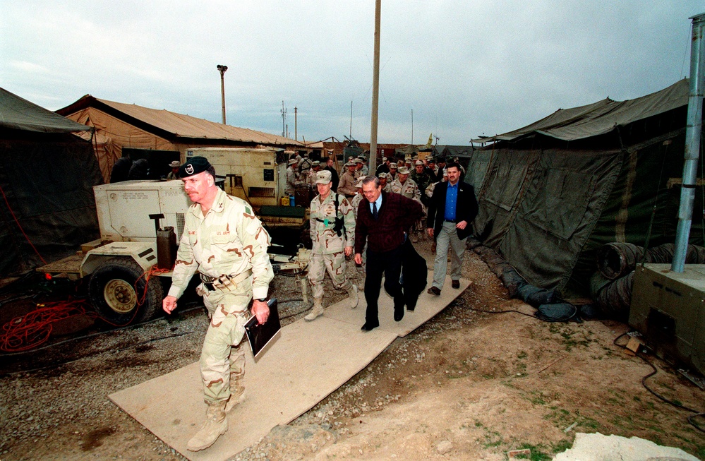 Col. John Mulholland, commander, 5th Special Forces Group, leads Secretary Rumsfeld and his official party.