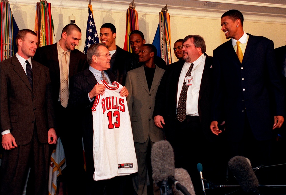 Secretary Rumsfeld accepts a team jersey from members of the Chicago Bulls.
