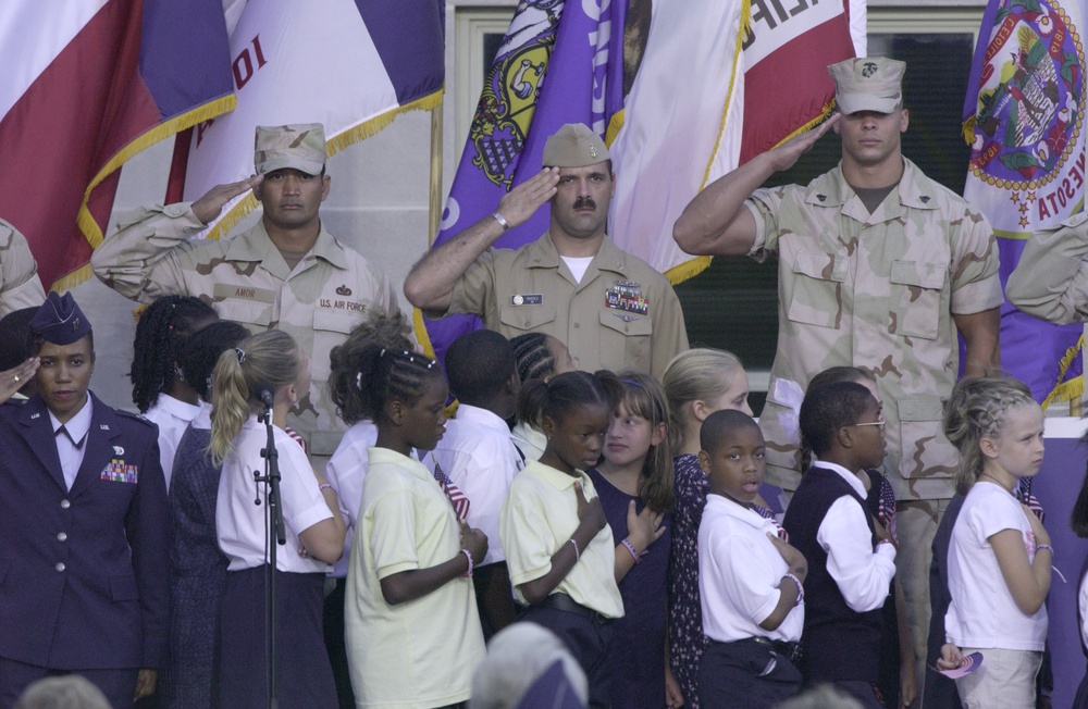 Children from local elementary and middle schools lead the reciting of the Pledge of Allegiance.
