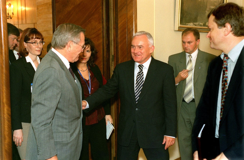 Polish Prime Minister Miller escorts Secretary Rumsfeld from a conference room in Warsaw, Poland.