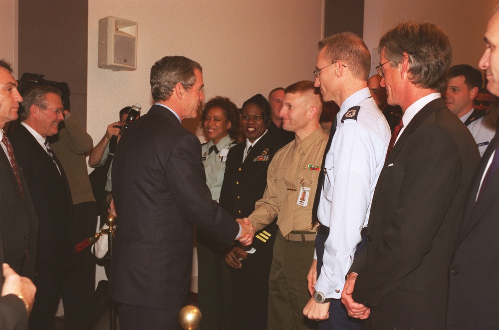 President Bush shakes hands with Marine Sgt. Robert J. Wenier as he leaves the Pentagon auditorium.