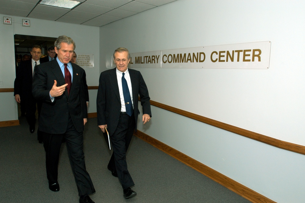 President Bush and Secretary Rumsfeld walk from the Pentagon's National Military Command Center.