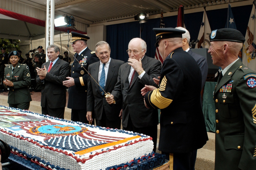 Vice President Cheney gets a taste of the frosting after cutting a cake during a ceremony commemorating the Army's 228th birthday.