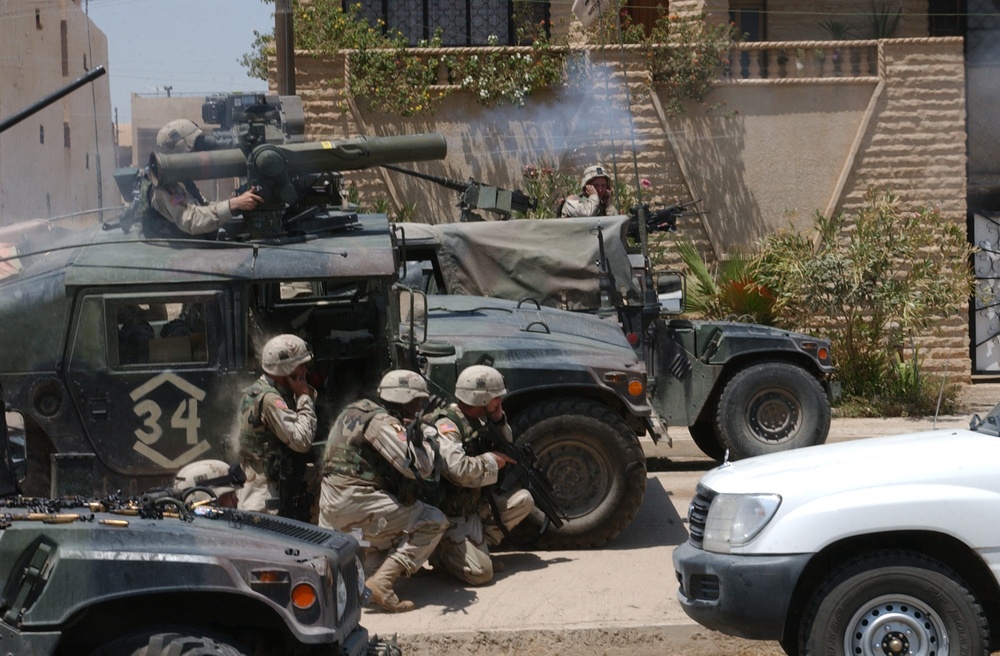 Soldiers of the 101st Airborne Division fire a TOW missile at a building suspected of harboring Saddam Hussein's sons.