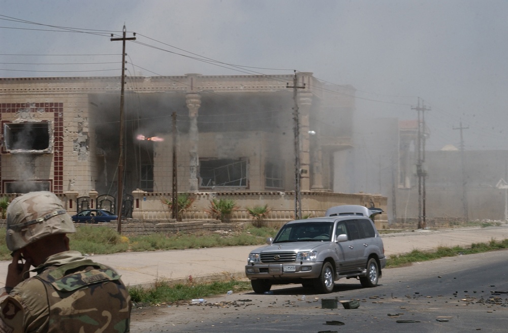 A TOW missile streaks toward a building suspected of harboring Saddam Hussein's sons Qusay and Uday in Mosul.