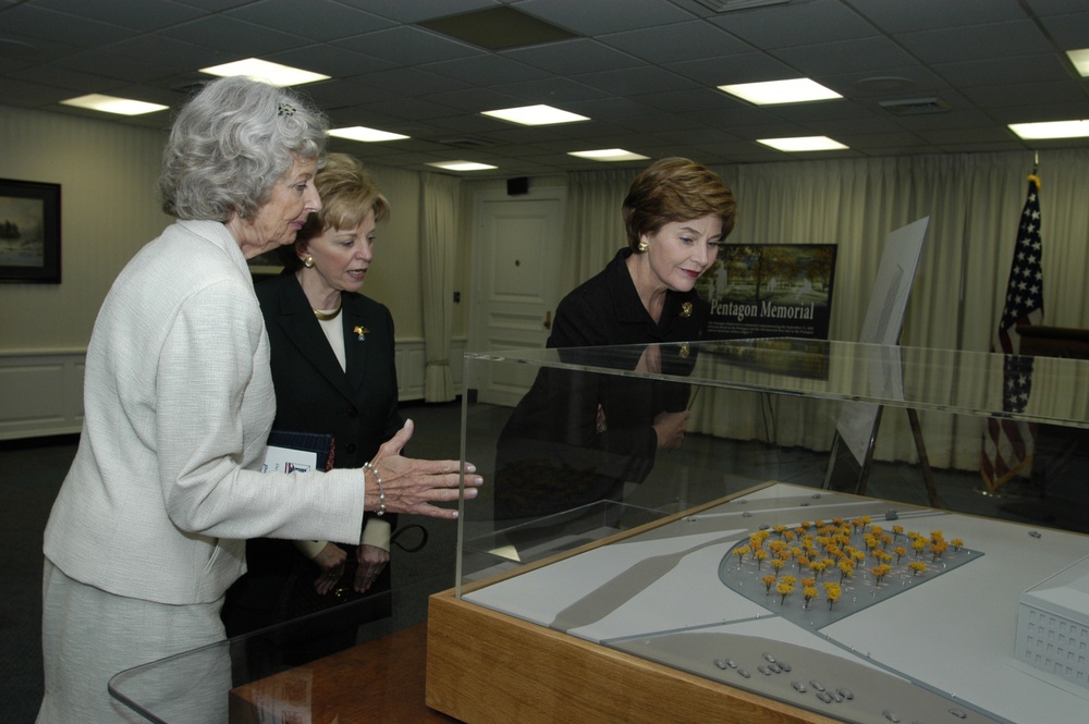 Mrs. Joyce Rumsfeld shows the model of the Pentagon Memorial to Mrs. Lynn Cheney and First Lady Laura Bush.