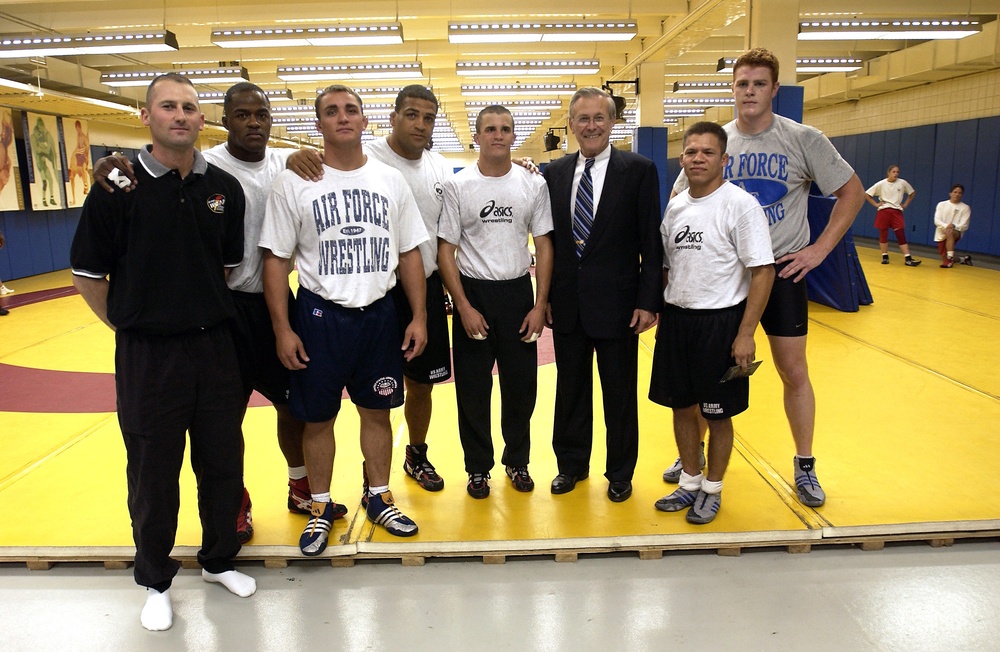 Secretary Rumsfeld poses for a photo with military wrestlers training at the U.S. Olympic Complex.