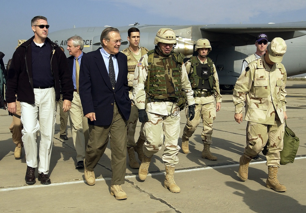 Secretary Rumsfeld walks with Lt. Gen. Ricardo Sanchez after arriving at Baghdad International Airport.