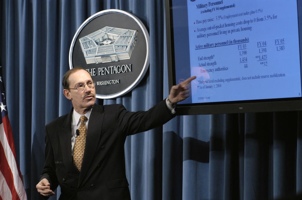 Under Secretary of Defense, Comptroller, Zakheim refers to a chart as he presents the Department of Defense 2005 budget.