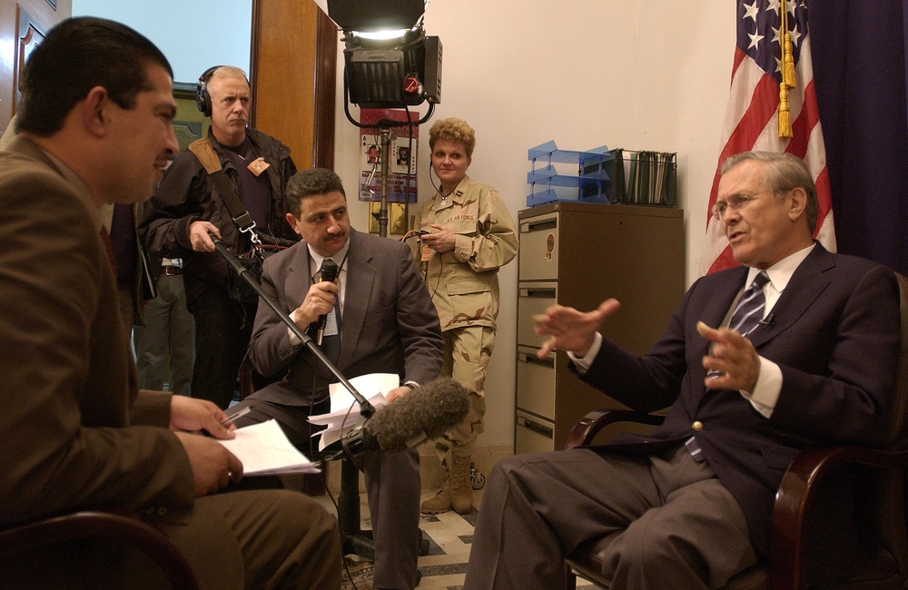 Secretary Rumsfeld talks to a Kuwaiti reporter during an interview at Coalition Provisional Authority headquarters in Iraq.
