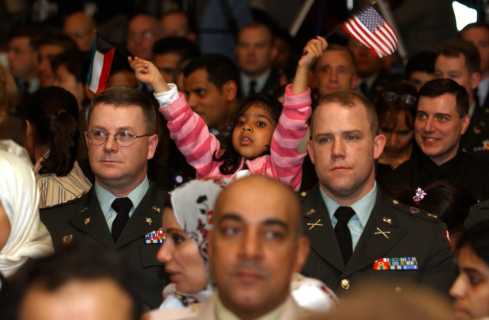 A young Kuwaiti girl waves both the United States and Kuwait flags at a Pentagon ceremony.