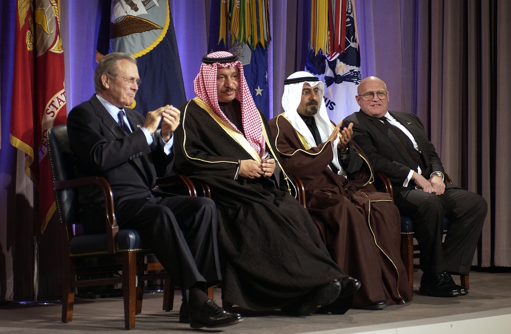 Secretary Rumsfeld and Kuwaiti Minister of Foreign Affairs Sheikh Mohammed Sabah Al-Salem Al-Sabah applaud during a ceremony.