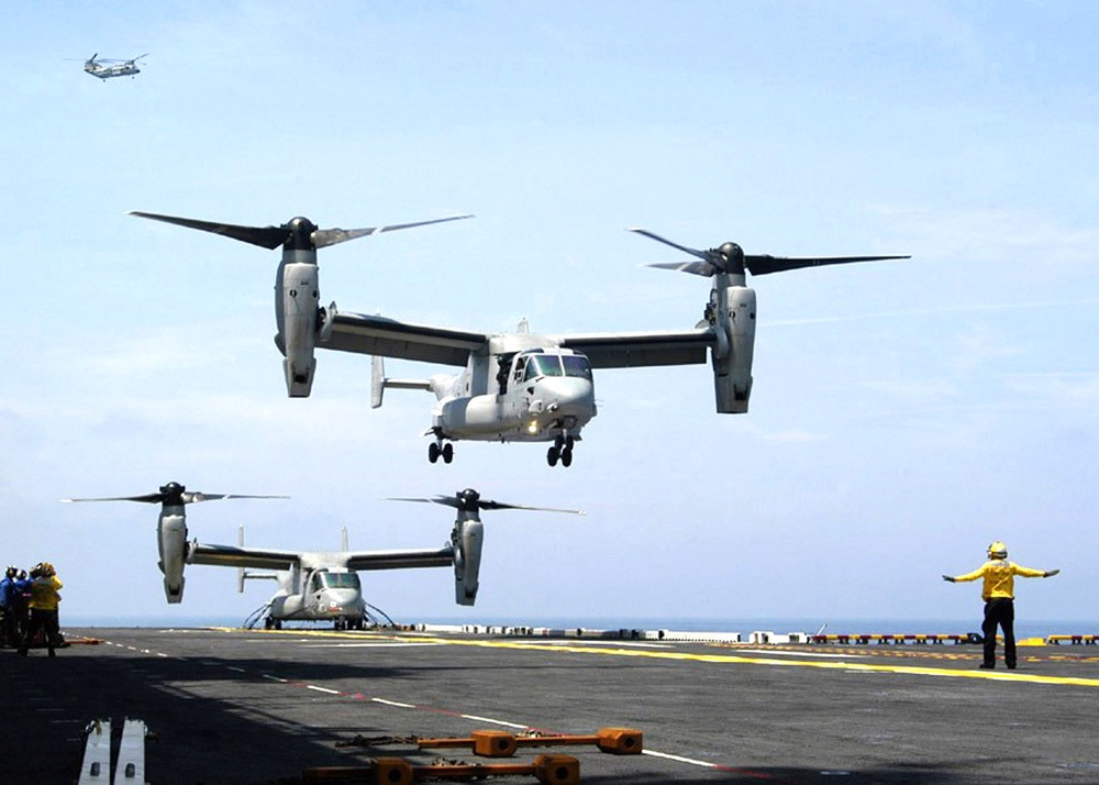 Two V-22 Osprey aircraft operate from the flight deck of the USS Iwo Jima (LHD 7).