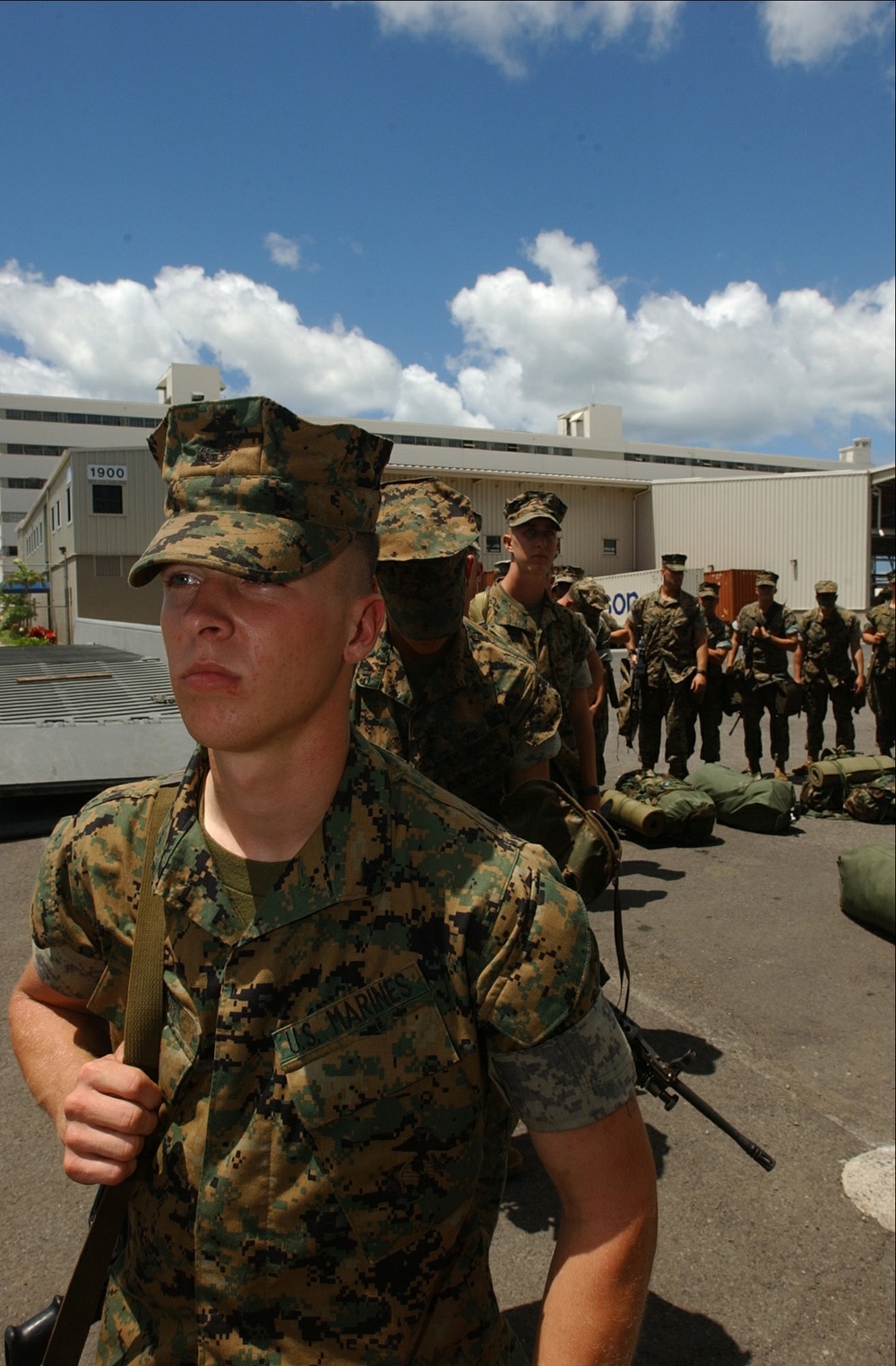 Marines line up to embark on the USS Tarawa (LHA 1).