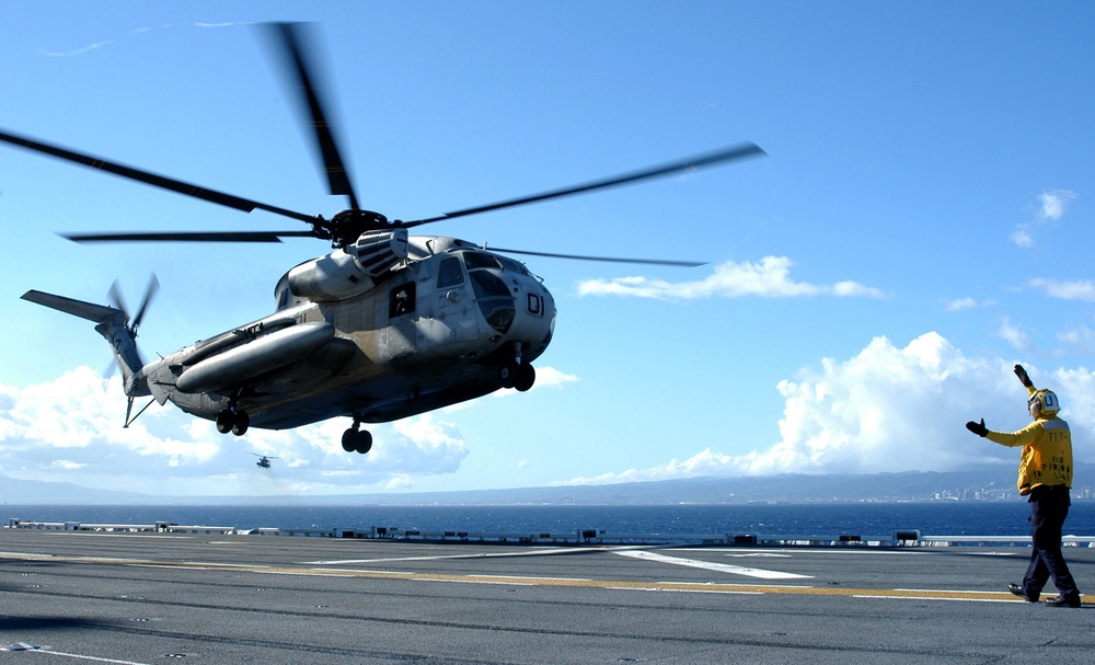 Petty Officer 3rd Class Chris Colyn directs a CH-53D Sea Stallion to land aboard the USS Tarawa (LHA 1).