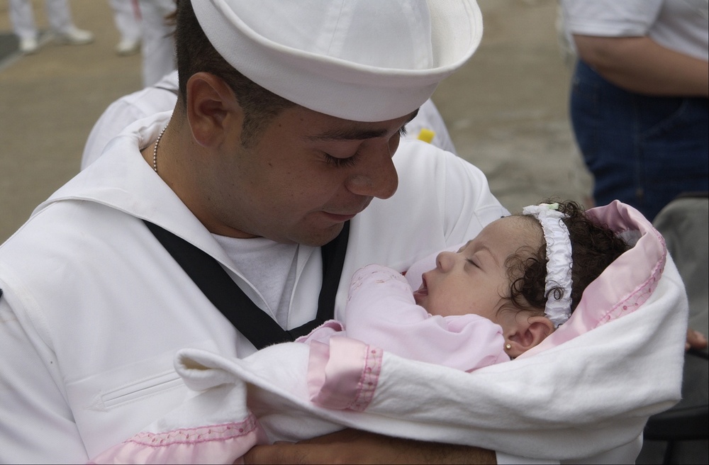 Seaman Vega holds his newborn daughter, Crystal Maria, for the first time.