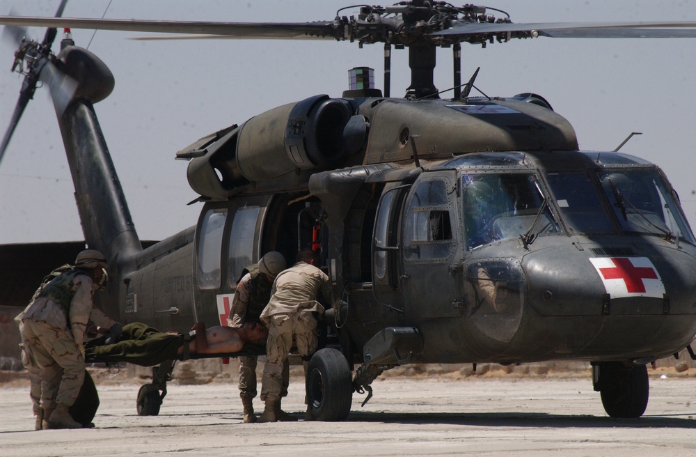 Army medics load a wounded Iraqi man into a UH-60 Black Hawk medical helicopter.