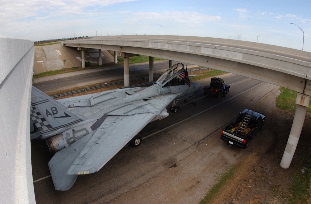 A U.S. Navy F-14A Tomcat clears an overpass by a few inches.