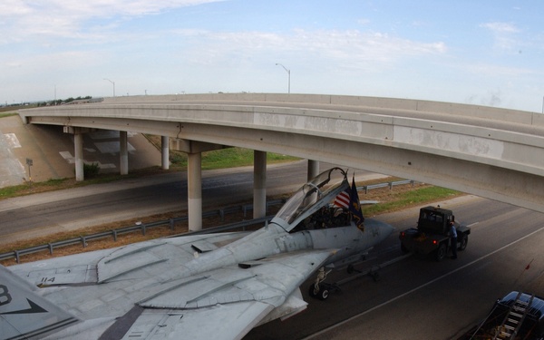 A U.S. Navy F-14A Tomcat clears an overpass by a few inches.