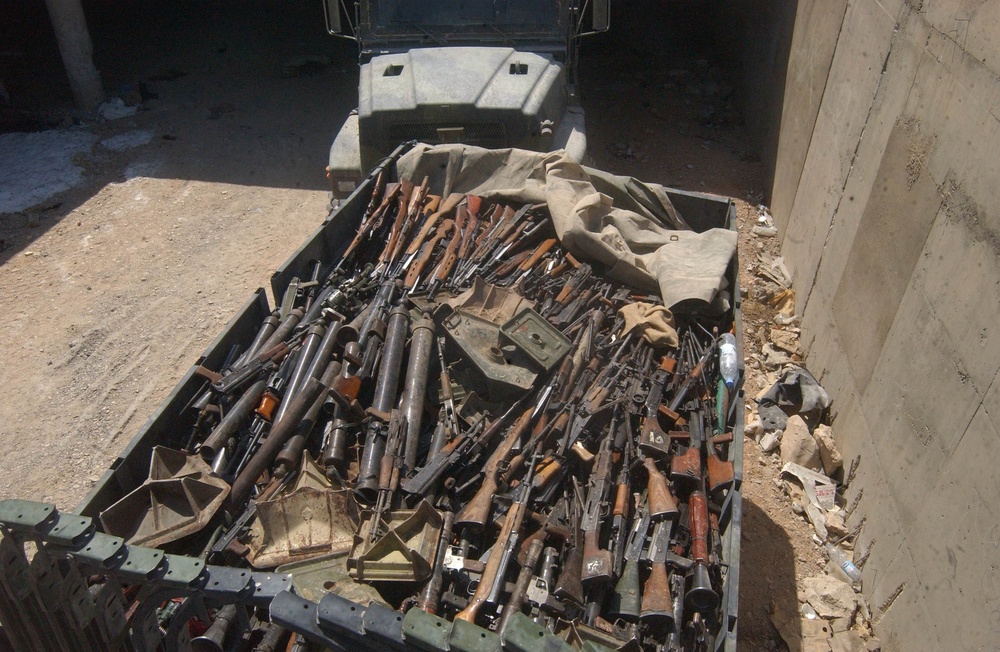 A U.S. Marine 7-ton truck stands full of captured and recovered weapons.