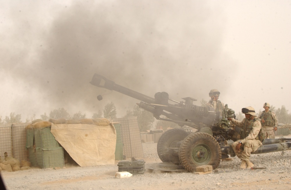 Soldiers fire an M119 Howitzer as part of a training exercise. Soldiers fire an M119 Howitzer as part of a training exercise.
