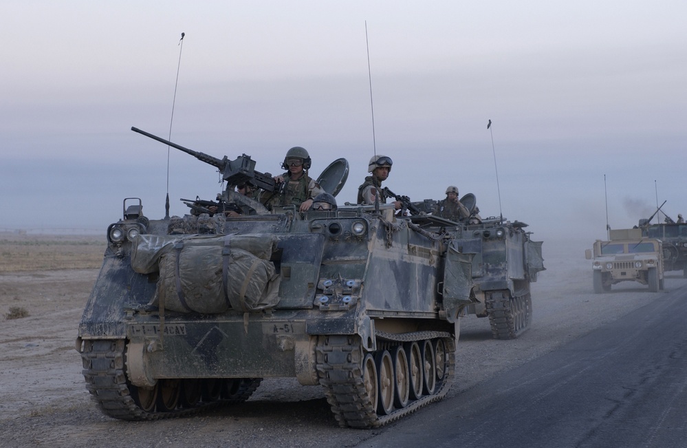 U.S. Army armored vehicles leave Samarra after conducting an assault.