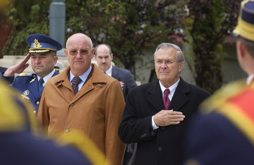 Secretary Rumsfeld stands with Romanian Minister of Defense Pascu as the band plays the U.S. National Anthem.