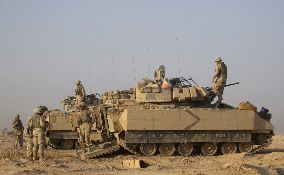 U.S. Army soldiers prepare themselves and their M2A2 Bradley Fighting Vehicles.