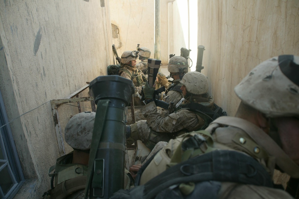 U.S. Marines take a break while searching the city of Al Fallujah, Iraq.