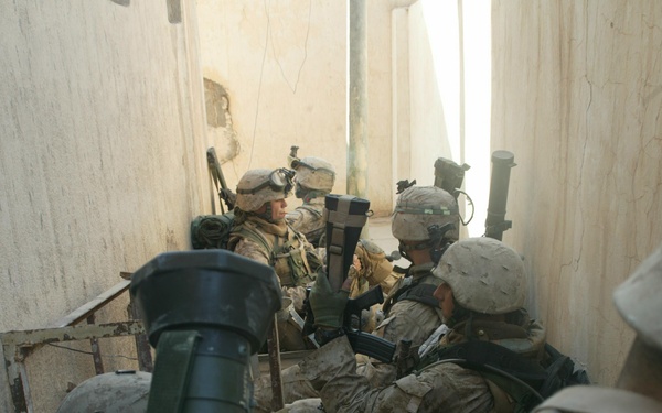 U.S. Marines take a break while searching the city of Al Fallujah, Iraq.