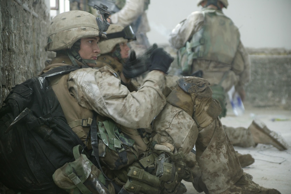 U.S. Marines take a break while searching the city of Al Fallujah, Iraq.