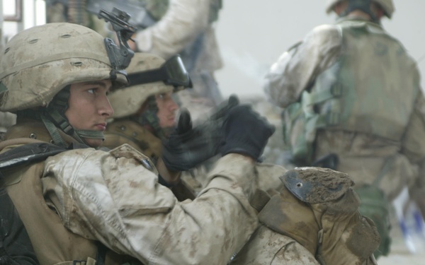 U.S. Marines take a break while searching the city of Al Fallujah, Iraq.