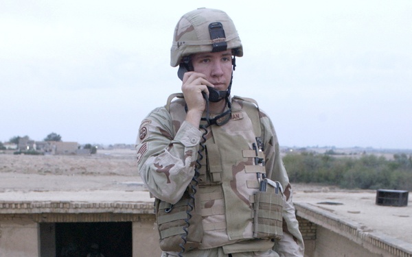 Staff Sgt. Michael Huffman communicates with a U.S. Navy F/A-18 Hornet.