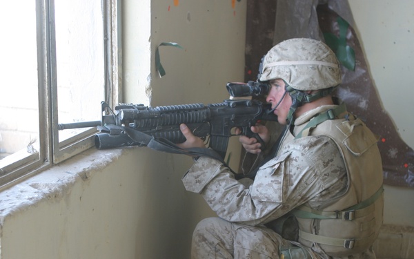A U.S. Marine watches for anything suspicious from a building in Fallujah, Iraq.
