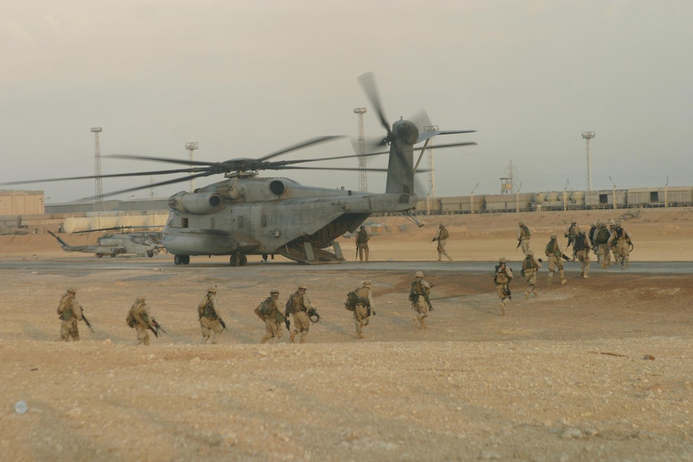 U.S. Marines board a CH-53 Sea Stallion helicopter.
