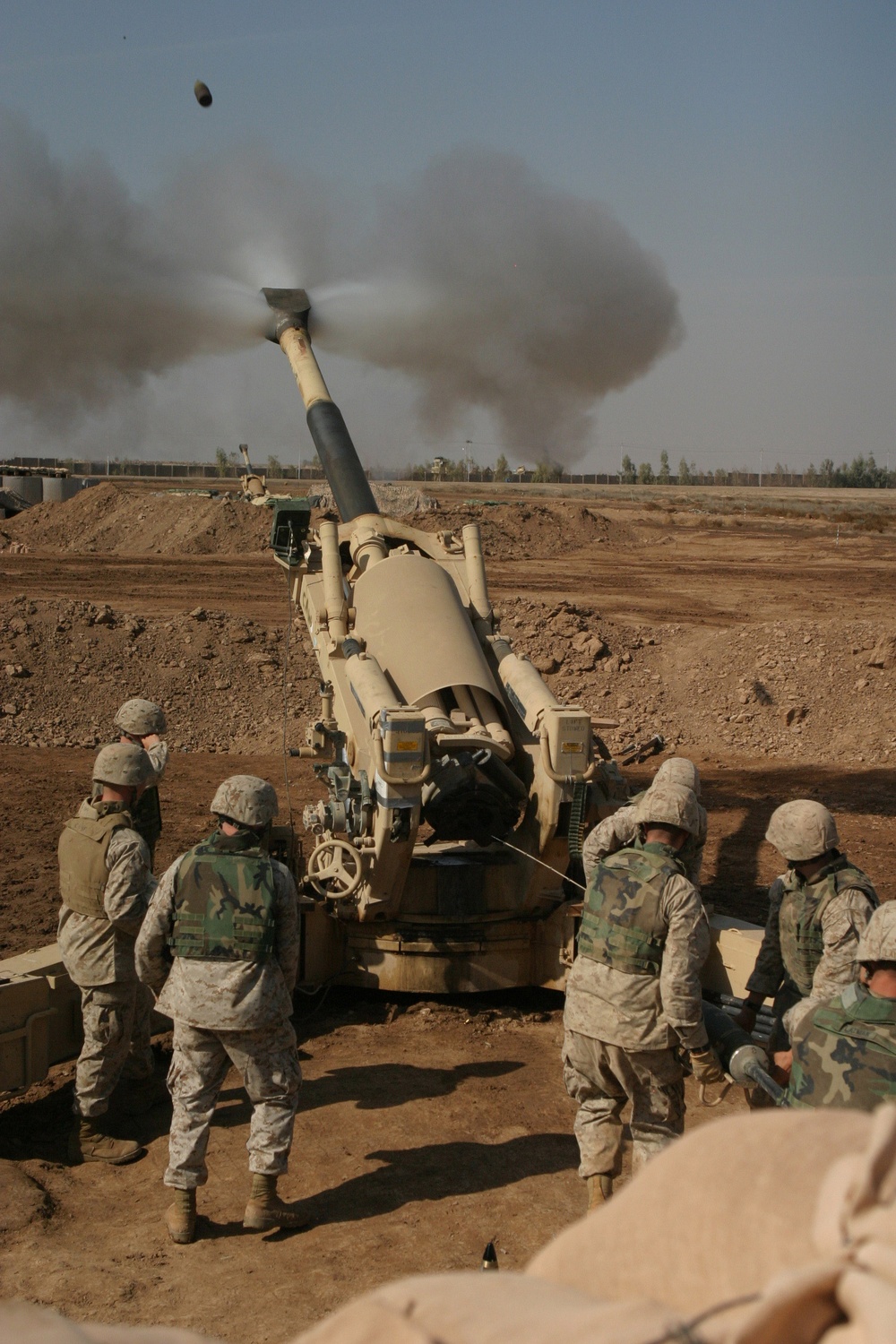 U.S. Marines fire their 155mm M198 Medium Howitzer on an insurgent position.