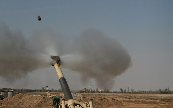 U.S. Marines fire their 155mm M198 Medium Howitzer on an insurgent position.