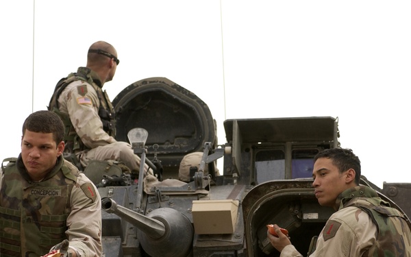 U.S. Army soldiers take a break aboard their M3A3 Bradley Cavalry Fighting Vehicle.