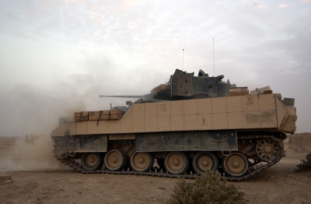 A U.S. Army M3A3 Bradley Cavalry Fighting Vehicle test fires its 25-millimeter chain gun.