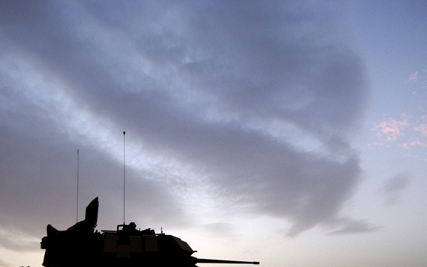 U.S. Army Spc. Jake Garrison keeps a look out by his M3A3 Bradley Cavalry Fighting Vehicle.