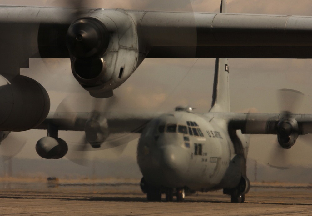 Two U.S. Air Force C-130 Hercules aircraft taxi to the runway.