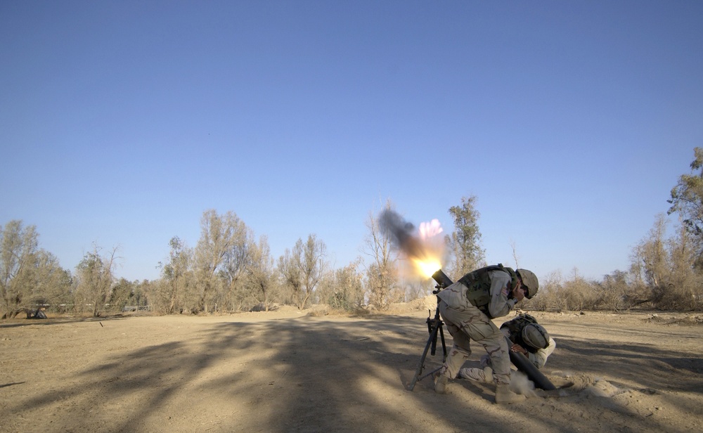 U.S. Army soldiers fire a 120-millimeter mortar round.
