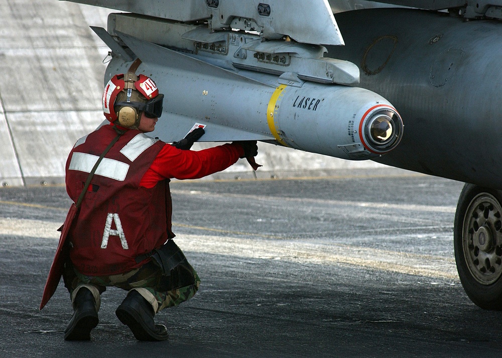 Petty Officer 3rd class William Miller arms an AGM-65 Maverick laser-guided missile.