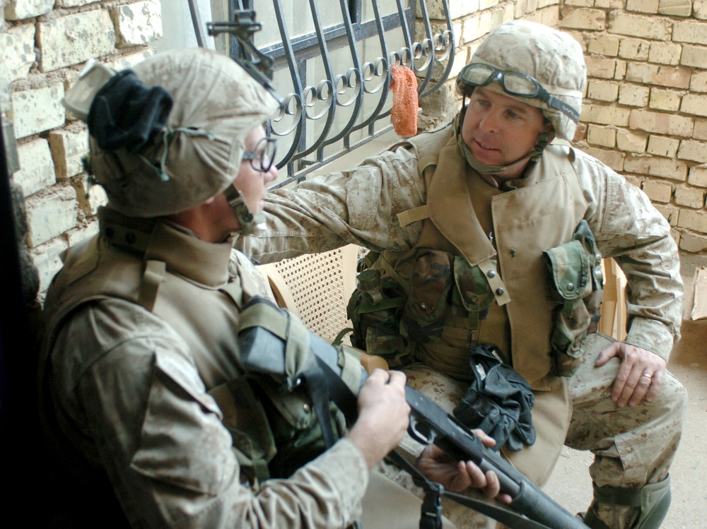 Navy Chaplain Lt. Kenny Lee talks with Lance Cpl. Kris Latorre.
