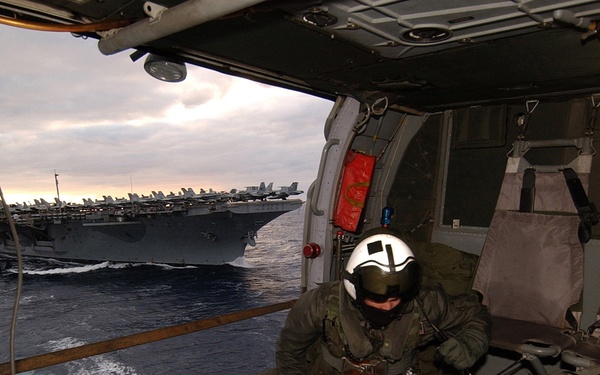 Navy aircrewmen keep a watchful eye below.