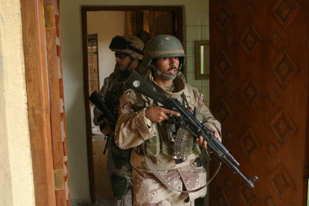Iraq Armed Forces soldiers and U.S. Marines clear buildings in Fallujah, Iraq.