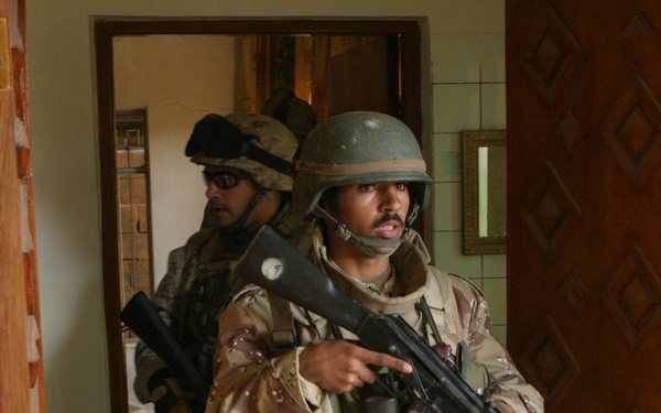 Iraq Armed Forces soldiers and U.S. Marines clear buildings in Fallujah, Iraq.