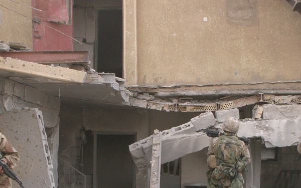 U.S. Marines and Iraqi Armed Forces soldiers clear buildings.
