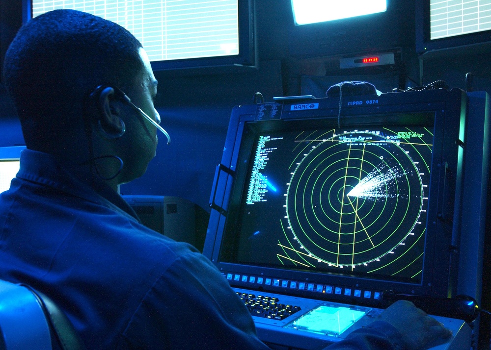 Petty Officer 3d class Corey Fowler controls inbound aircraft.